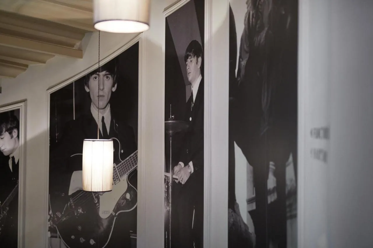 a room with pictures of musicians on the walls at Hard Days Night Hotel Liverpool in Liverpool
